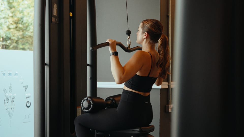 Woman on a cable row machine in a gym