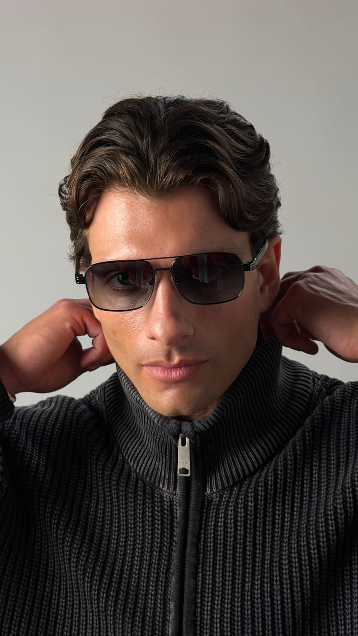 Model in aviator sunglasses and a knit zip jacket, shot on iPhone